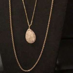 Necklace with light pink pendant.